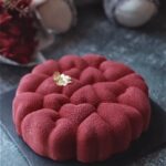 Decadent strawberry mousse cake with a vibrant red hue with velvet texture.